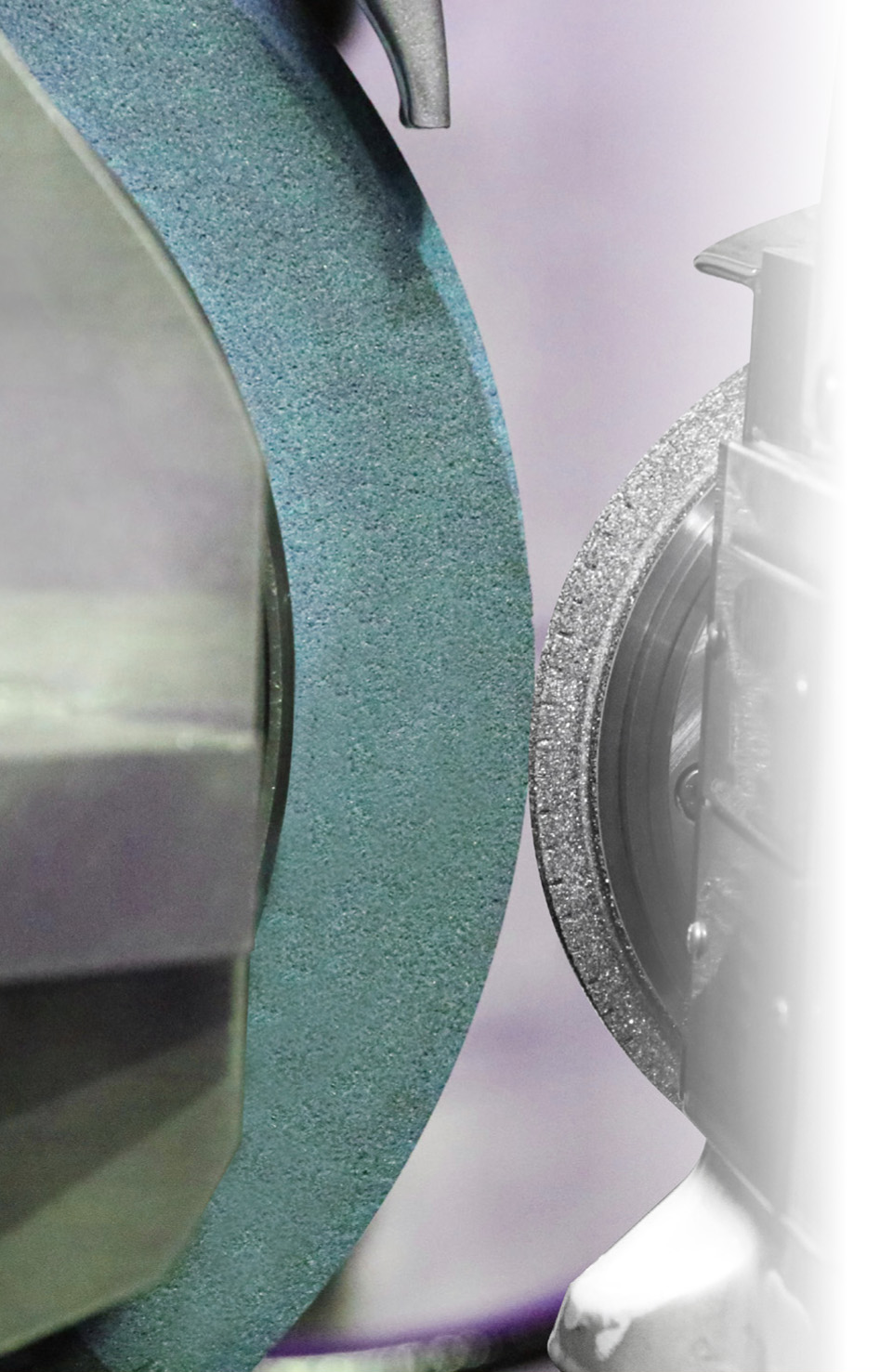 Diamond dressing roll in contact with a profiled grinding wheel.